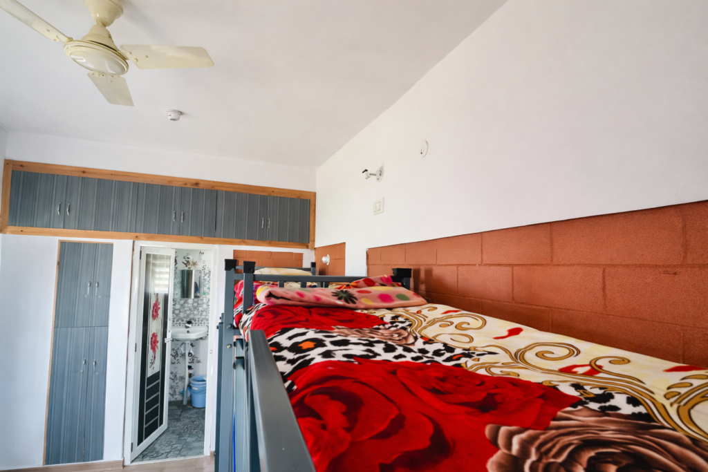 Shared dormitory with bunk bed and bathroom